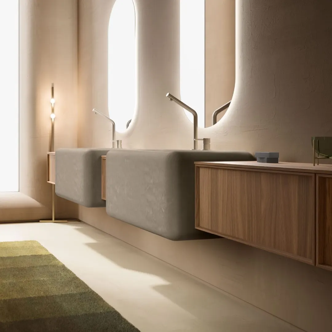 Bagno finito con doppio lavabo integrato su base sospesa e specchi tondi retroilluminati